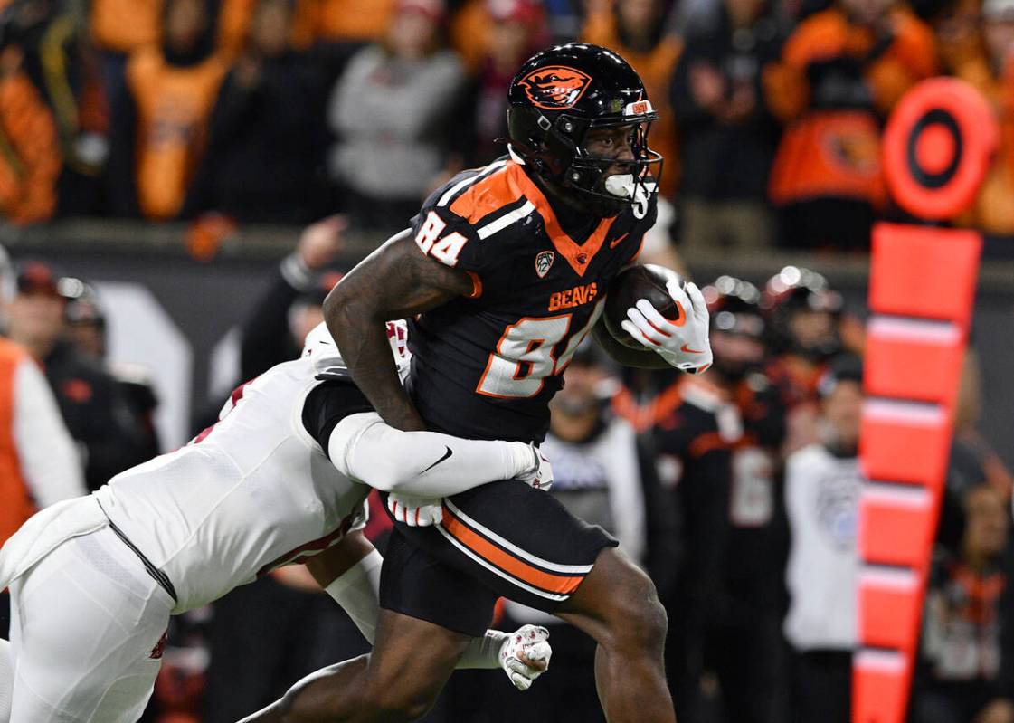 Oregon State tight end Jermaine Terry II (84) pulls Washington State defensive back Kapena Gush ...