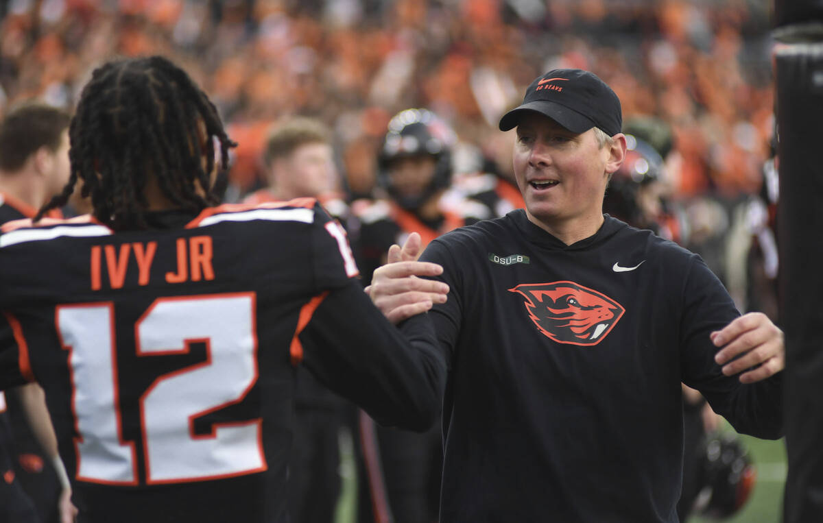 Oregon State head coach Trent Bray greets senior defensive back Tyrice Ivy Jr. before playing W ...