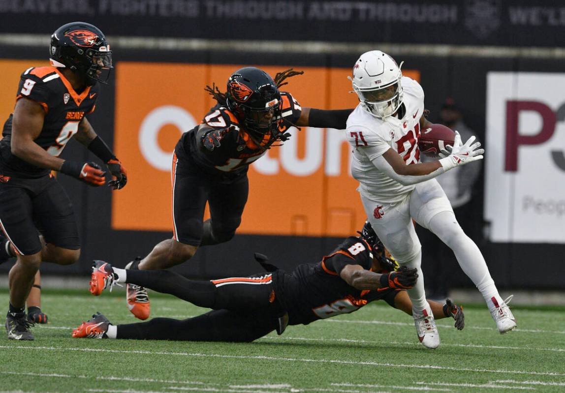 Oregon State defensive back Sailasa Vadrawale III (8), defensive back Skyler Thomas (17) and li ...