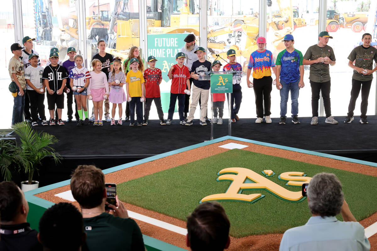 Little League players sing “Take Me Out to the Ball Game” with guests during a gr ...