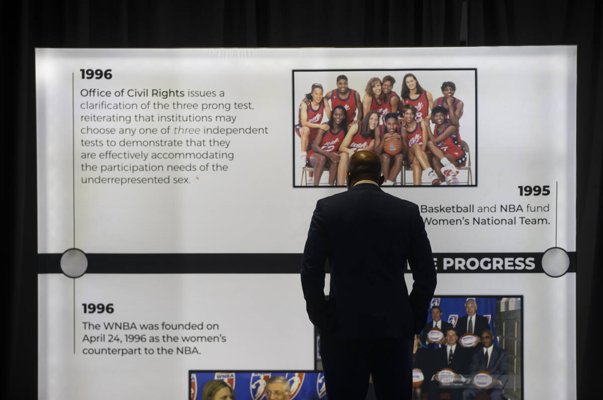 An attendee looks at a timeline of events related to Title IX leading to the red carpet for The ...
