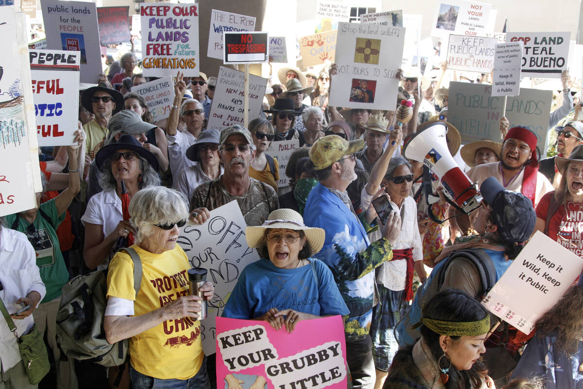 Hundreds of people protest efforts to privatize federal public land in Santa Fe, N.M., outside ...