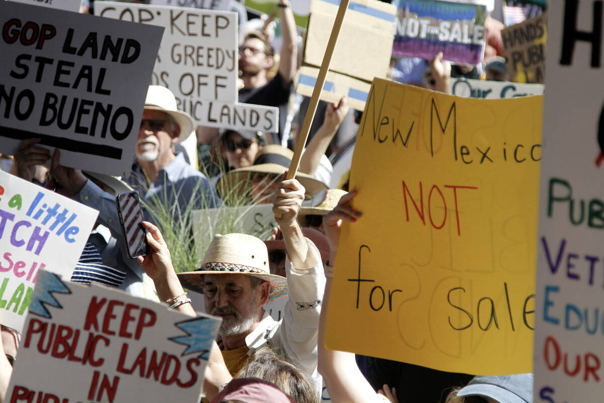 Hundreds of people protest efforts to privatize federal public land in Santa Fe, N.M., outside ...