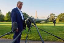President Donald Trump speaks with reporters before boarding Marine One on the South Lawn of th ...