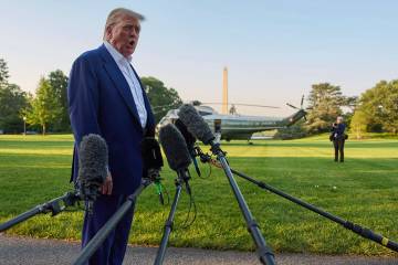 President Donald Trump speaks with reporters before boarding Marine One on the South Lawn of th ...