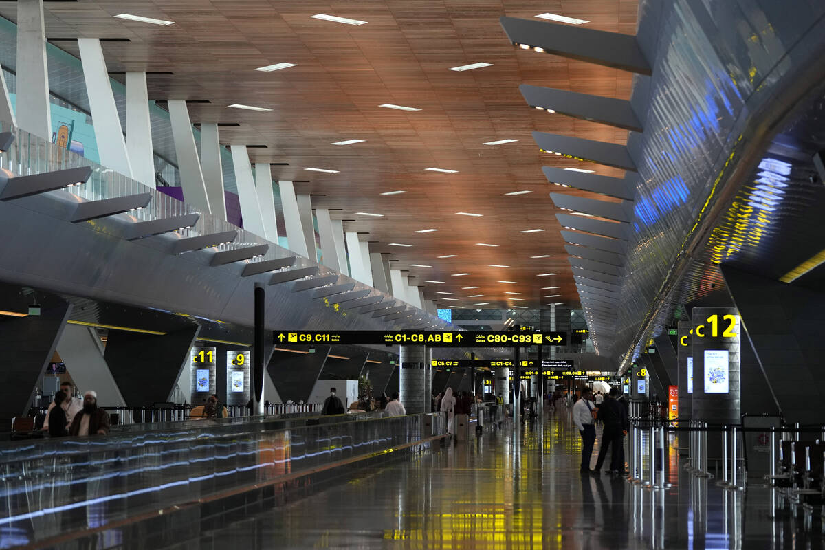 FILE - Passengers walk at Hamad International Airport in Doha, Qatar, Nov. 10, 2022. (AP Photo/ ...