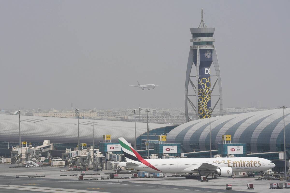 FILE - An Emirates Boeing 777 stands at the gate at Dubai International Airport as another prep ...