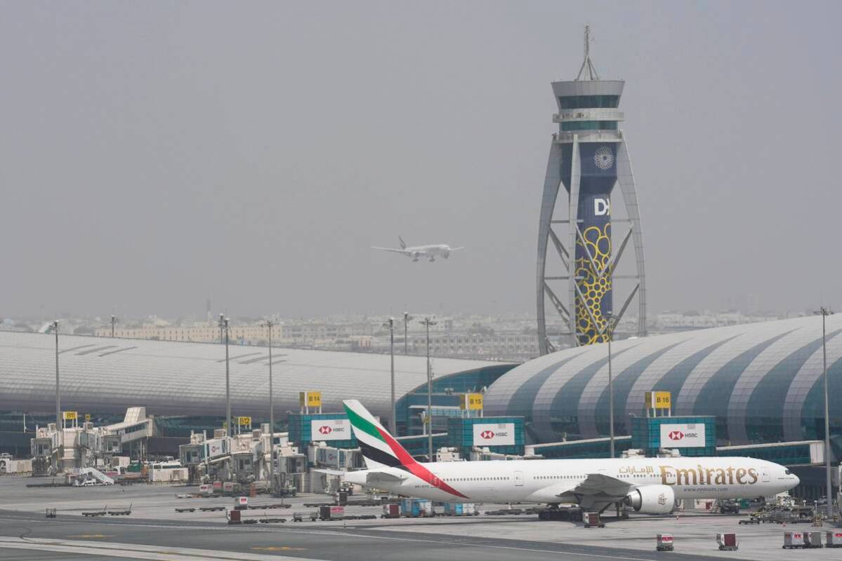 FILE - An Emirates Boeing 777 stands at the gate at Dubai International Airport as another prep ...