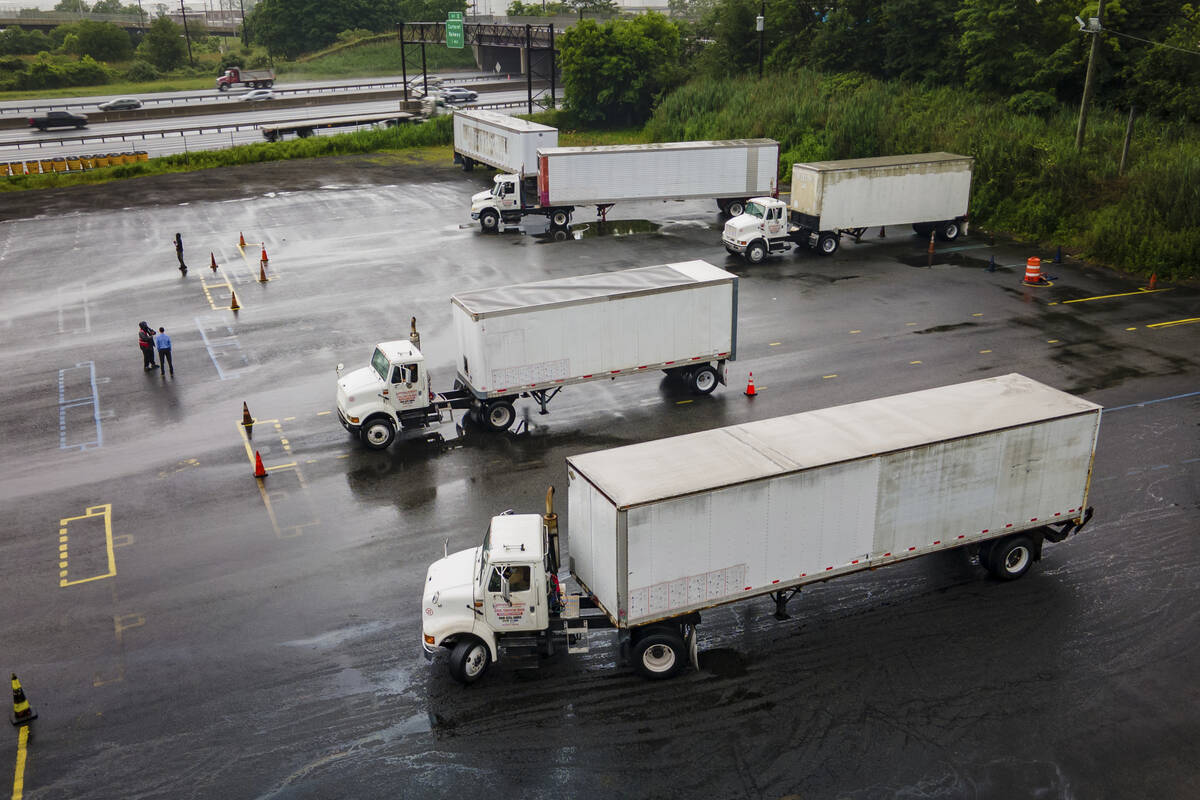 Trucking students practice reverse parking in training trucks at the Driving Academy on Thursda ...