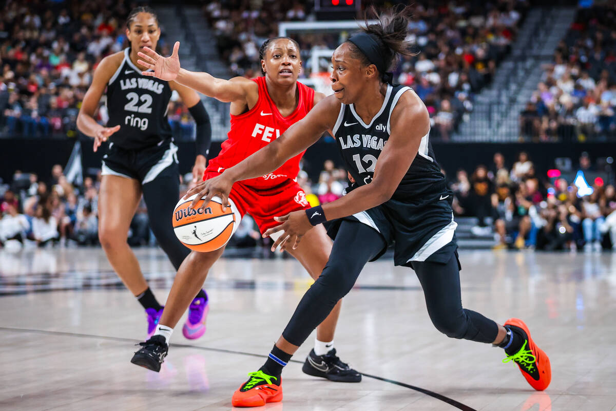 Aces guard Chelsea Gray (12) passes the ball during a WNBA basketball game between the Aces and ...