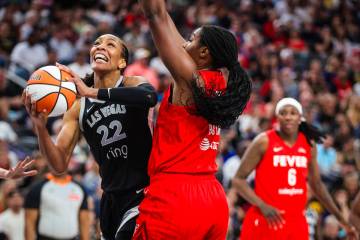Aces center A'ja Wilson (22) puts up a shot against Indiana Fever forward Aliyah Boston (7) dur ...