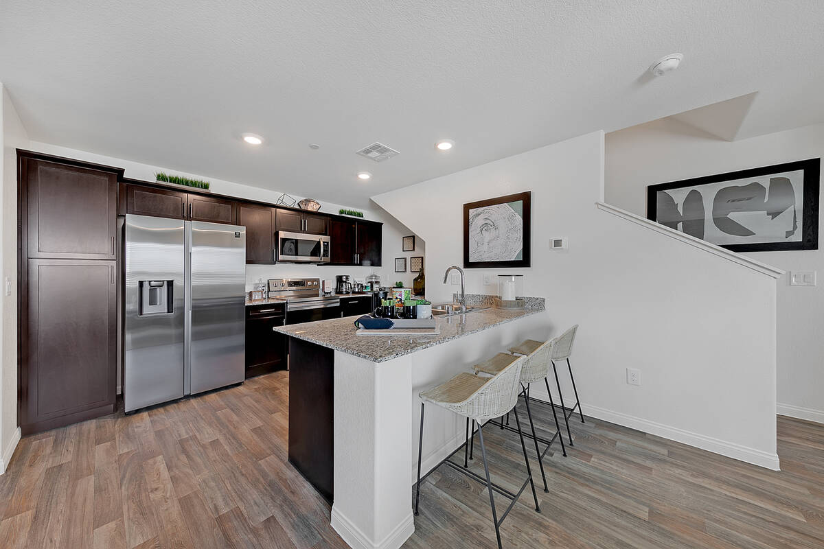 The kitchen has an island with seating. (Touchstone Living)