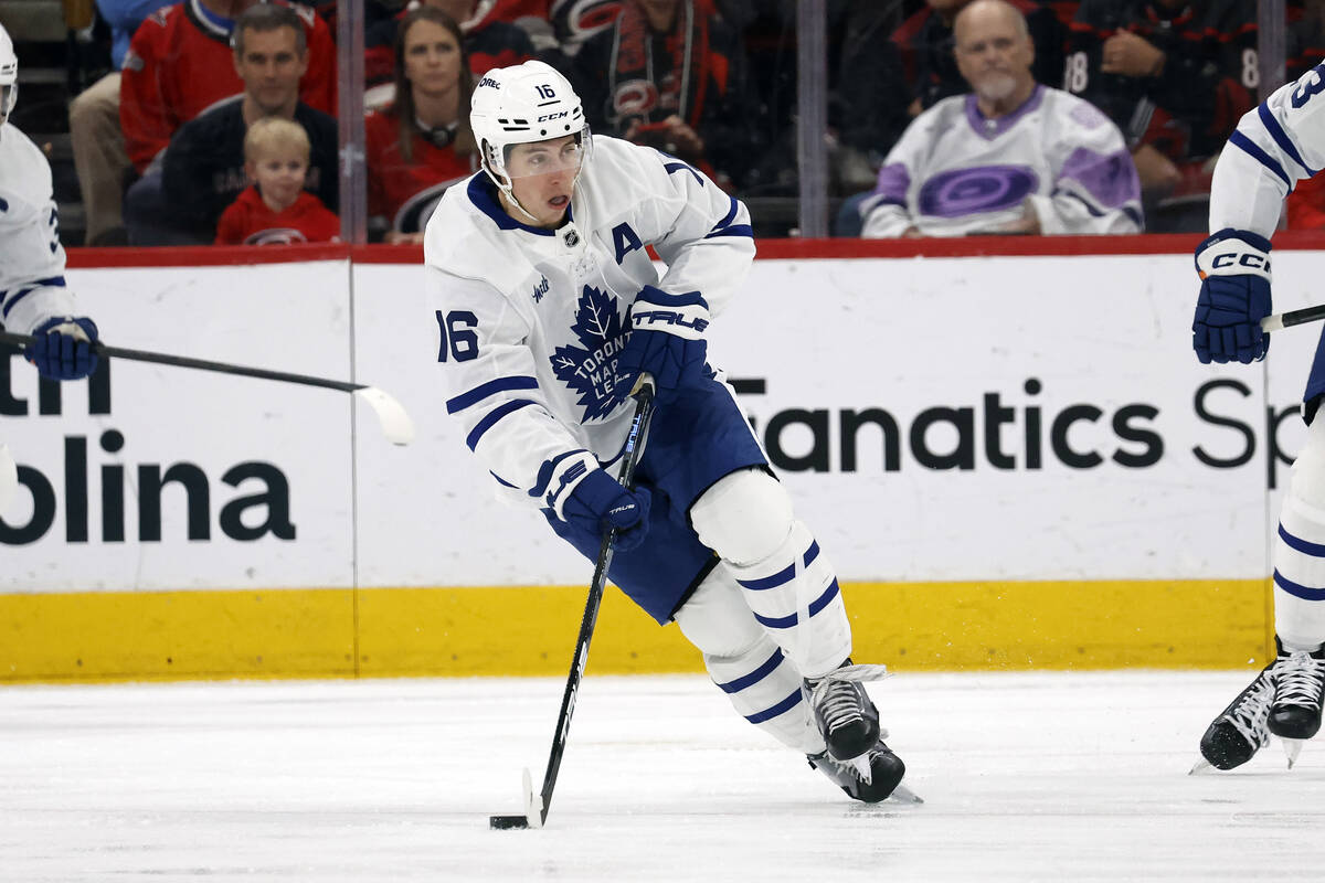 Toronto Maple Leafs' Mitch Marner (16) skates with the puck against the Carolina Hurricanes dur ...
