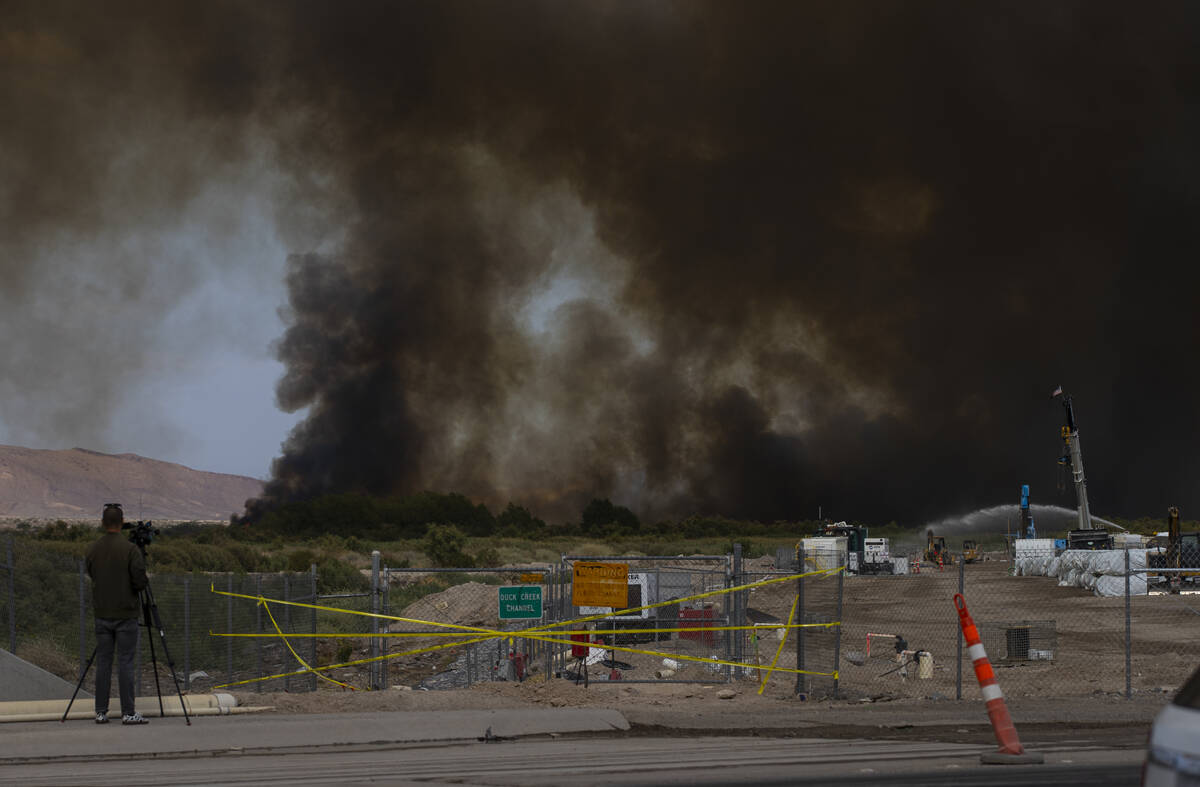 Smoke rises from a fire at the Clark County Wetlands Park on Tuesday, June 24, 2025, in Las Veg ...