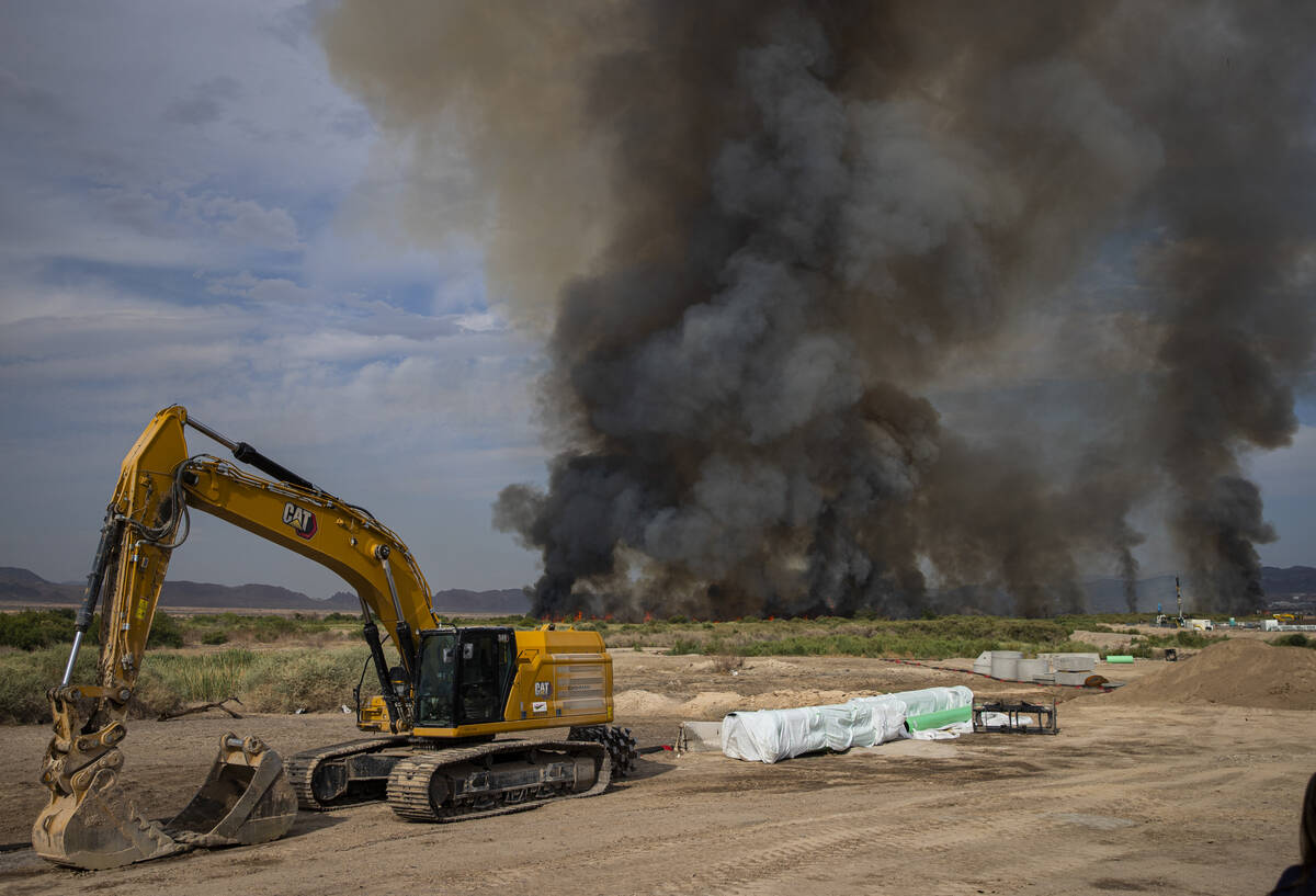 A plume of smoke rises from a fire at the Clark County Wetlands Park on Tuesday, June 24, 2025, ...