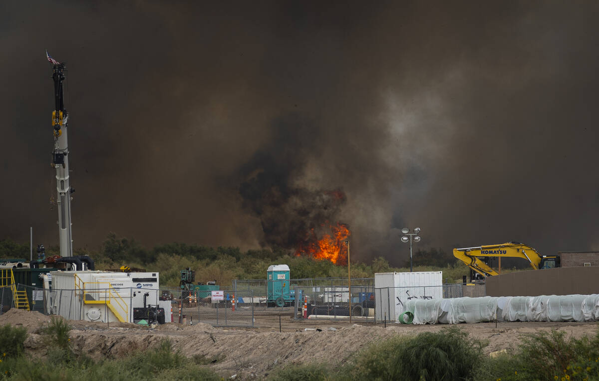 A fire burns at the Clark County Wetlands Park on Tuesday, June 24, 2025, in Las Vegas. (Chase ...