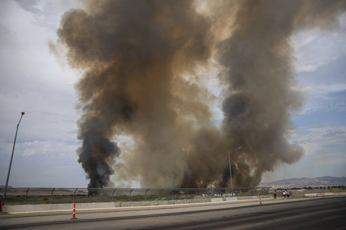 A plume of smoke rises from a fire at the Clark County Wetlands Park on Tuesday, June 24, 2025, ...