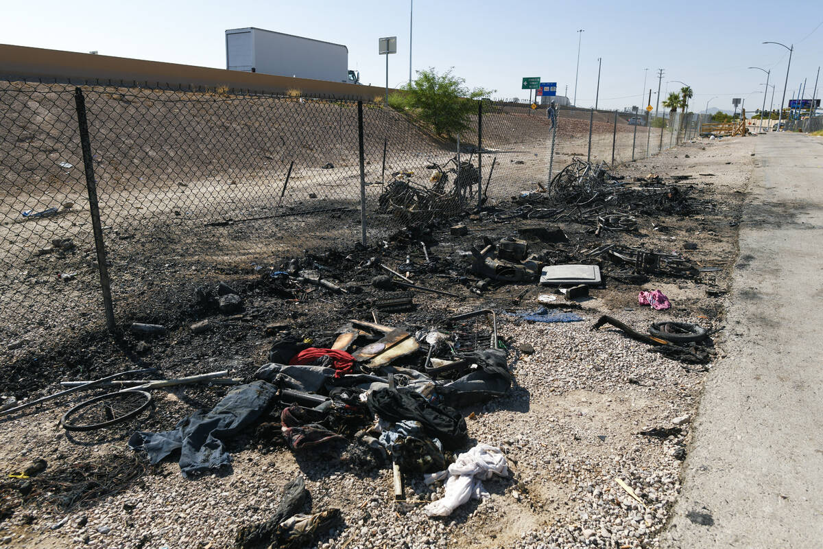 Charred debris from a homeless encampment is seen along Interstate 11 between the Boulder Highw ...