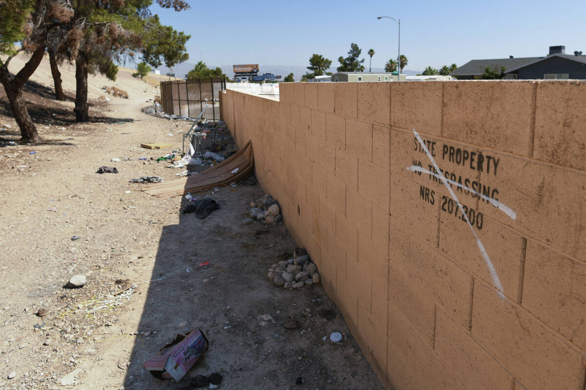 Debris from homeless encampments is seen along Interstate 11 between the Boulder Highway and Ch ...