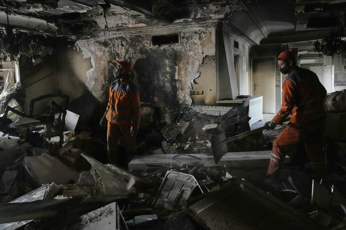 Workers clear rubble of a damaged building, in Tehran, Iran, Wednesday, June 25, 2025, after an ...
