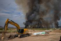 A plume of smoke rises from a fire at the Clark County Wetlands Park on Tuesday, June 24, 2025, ...