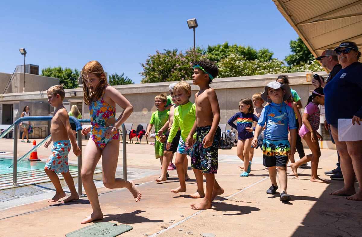 Children head to the pool for the World’s Largest Swim Lesson at the Boulder City Munici ...
