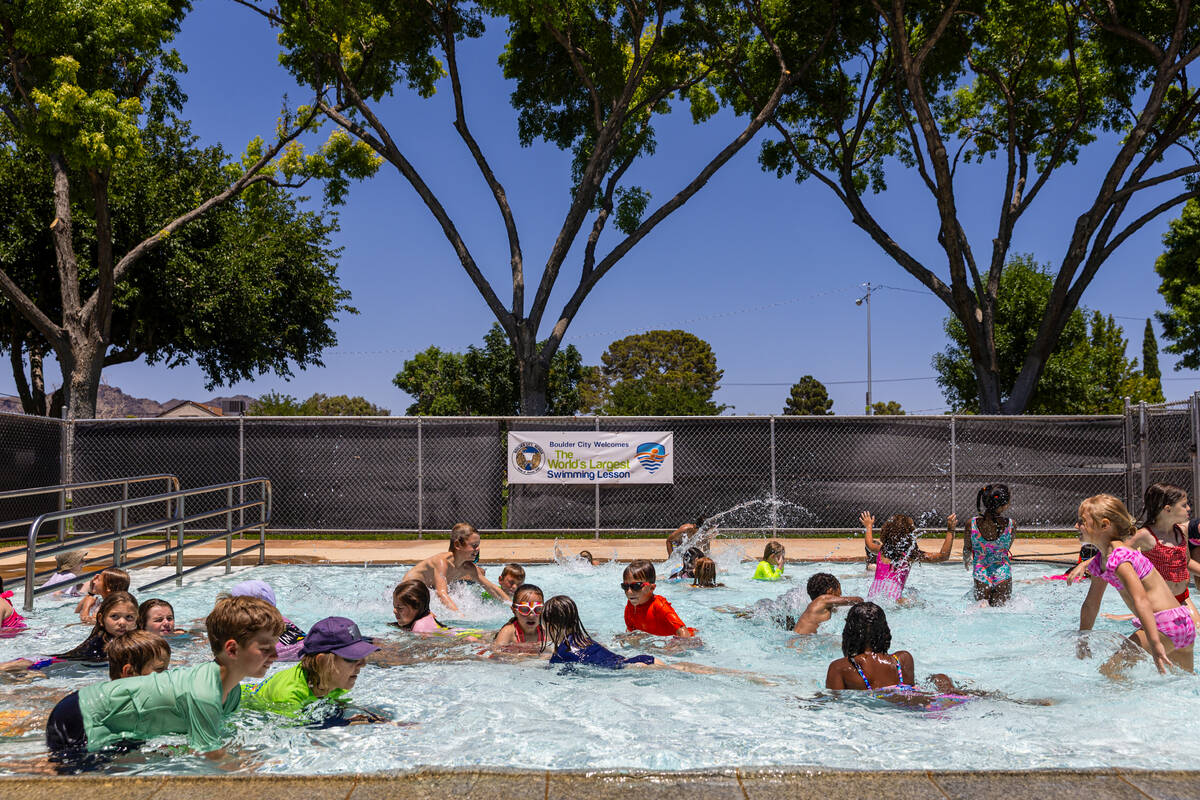 Children play in a pool following the World’s Largest Swim Lesson at the Boulder City Mu ...