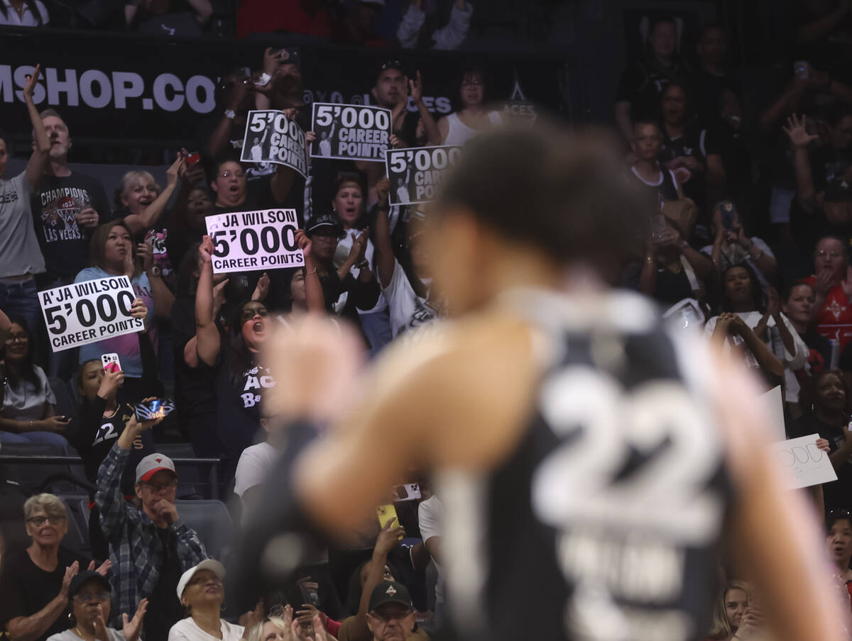 Fans cheer as Aces center A'ja Wilson (22) reaches 5,000 career points during the first half of ...