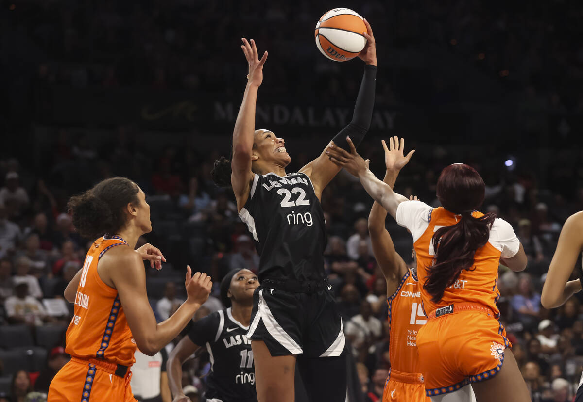 Aces center A'ja Wilson (22) vies for a rebound against Connecticut Sun forward Aneesah Morrow, ...
