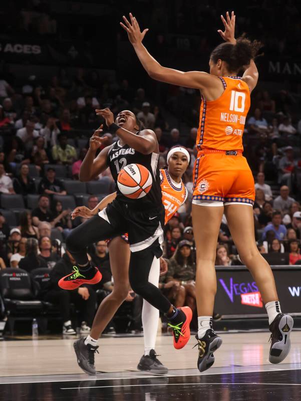 Aces guard Chelsea Gray (12) gets fouled by Connecticut Sun forward Aneesah Morrow (24) during ...