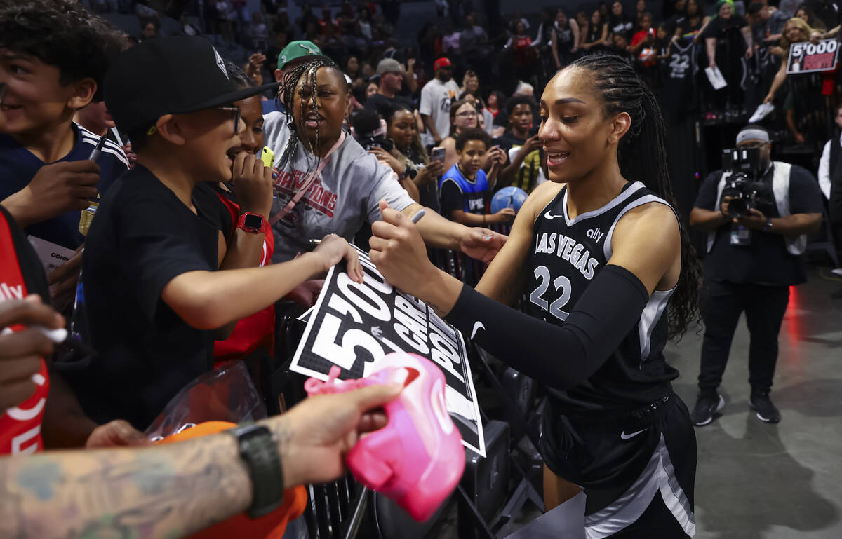 Aces center A'ja Wilson (22) signs autographs after reaching 5,000 career points in a win over ...