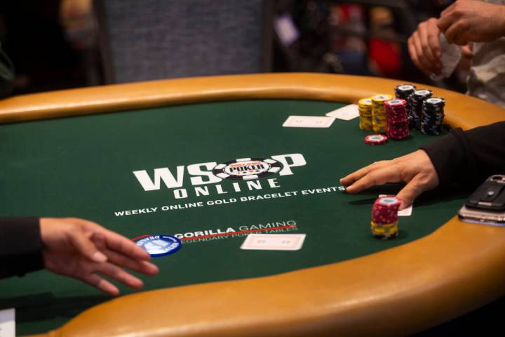 A dealer passes out cards during the $500 industry employees no-limit hold'em event during the ...