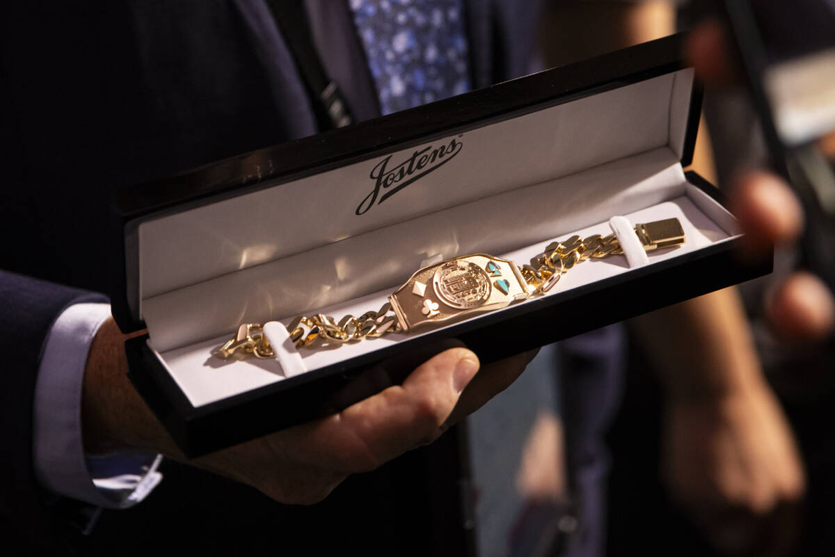 World Series of Poker tournament shift manager Bob Smith shows off the winner’s bracelet ...