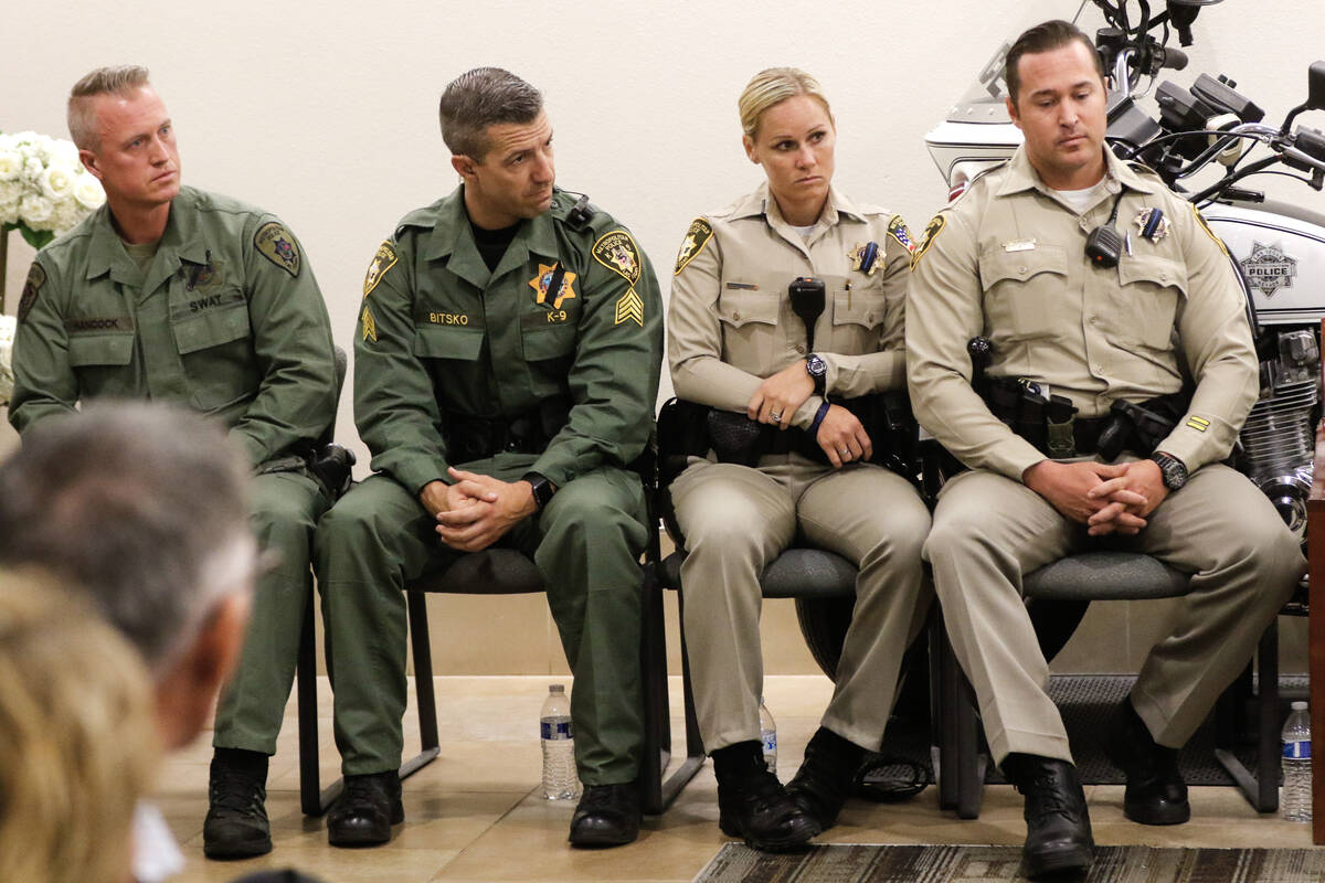 First responders, including Las Vegas police SWAT officer Levi Hancock, left, listen to Preside ...