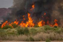A fire burns at the Clark County Wetlands Park on Tuesday, June 24, 2025, in Las Vegas. (Chase ...
