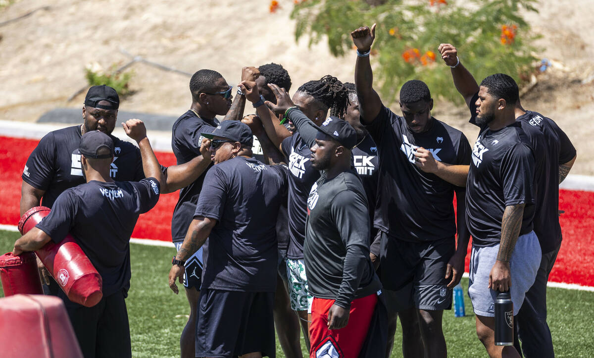 NFL defensive players come together after completing a series of drills during Sack Summit 2025 ...