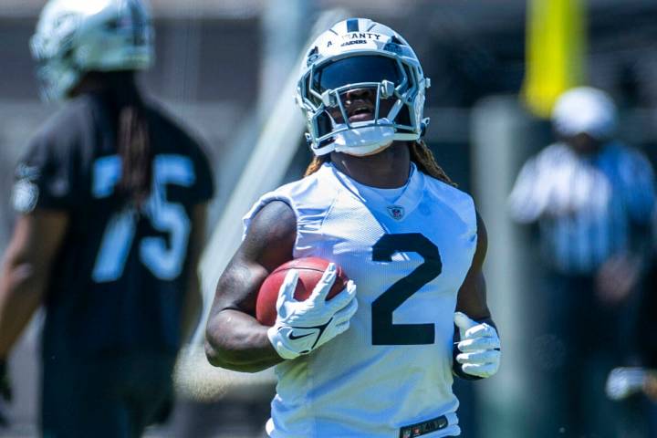 Raiders running back Ashton Jeanty (2) runs the ball up the field during Raiders OTA practice a ...