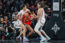 Aces center A'ja Wilson (22) is sandwiched by Washington Mystics defenders during a WNBA game b ...