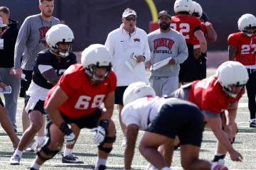 UNLV football offensive line coach Mike Sollenne, left, and head coach Dan Mullen watche their ...