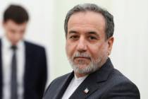Iranian Foreign Minister Abbas Araghchi stands waiting to meet Russian President Vladimir Putin ...