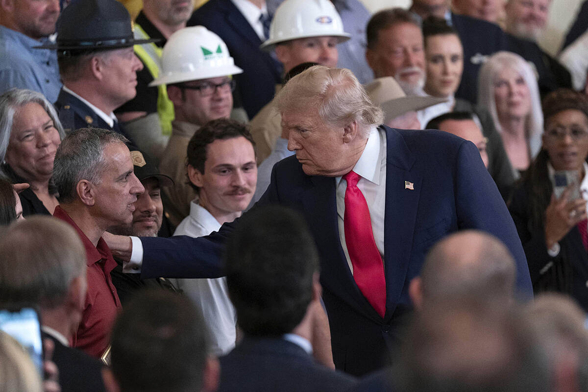 President Donald Trump, right, speaks with Joe Abraham, father of Katie Abraham, during an even ...