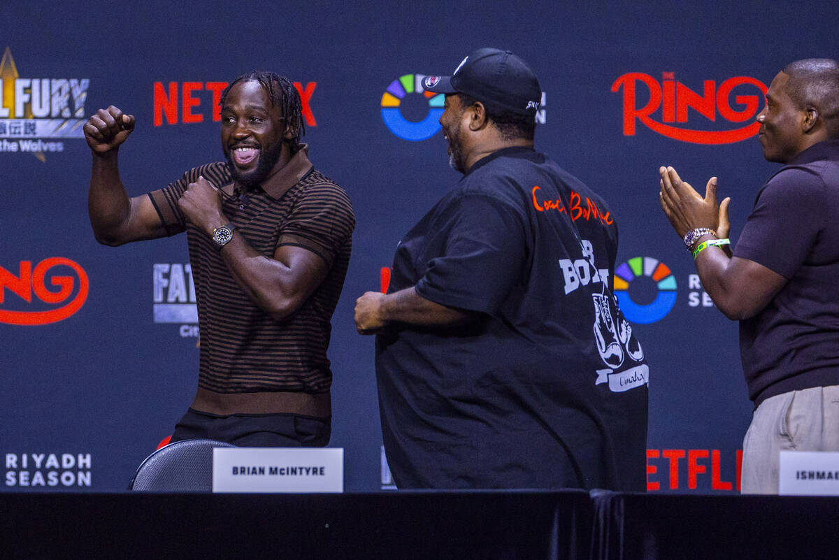 Terence Crawford dances while talking the stage as his trainer Brian McIntyre looks on during a ...