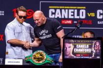 Canelo Alvarez greets Dana White during a press conference for a boxing match between Terence C ...