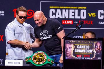 Canelo Alvarez greets Dana White during a press conference for a boxing match between Terence C ...