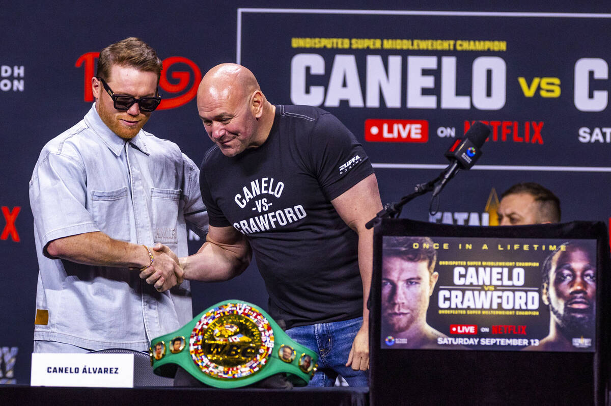 Canelo Alvarez greets Dana White during a press conference for a boxing match between Terence C ...