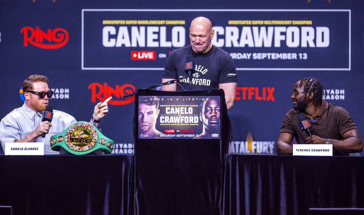 Canelo Alvarez and Terence Crawford exchange words as Dana White looks on during a press confe ...