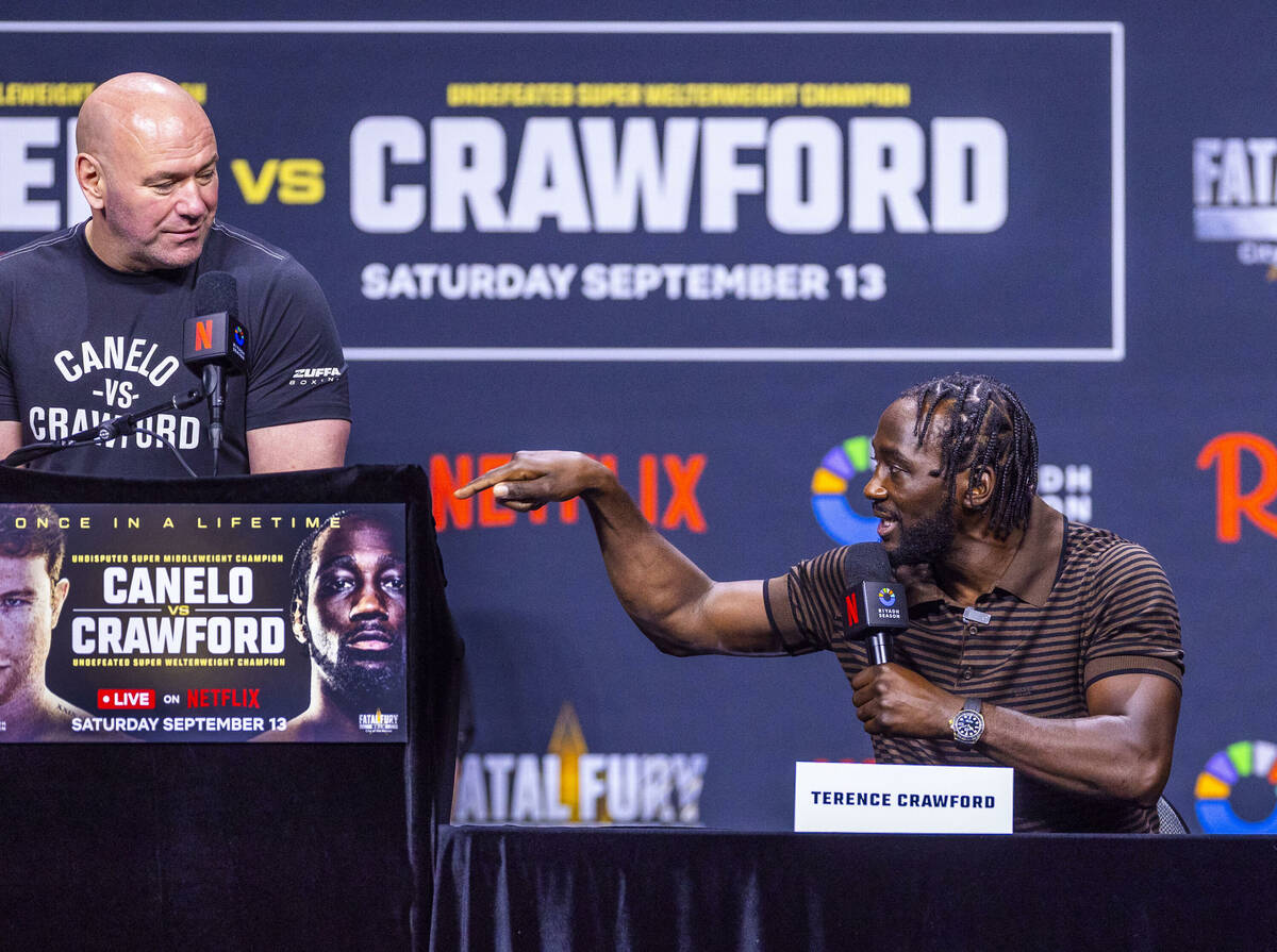 Terence Crawford has words for Canelo Alvarez as Dana White looks on during a press conference ...