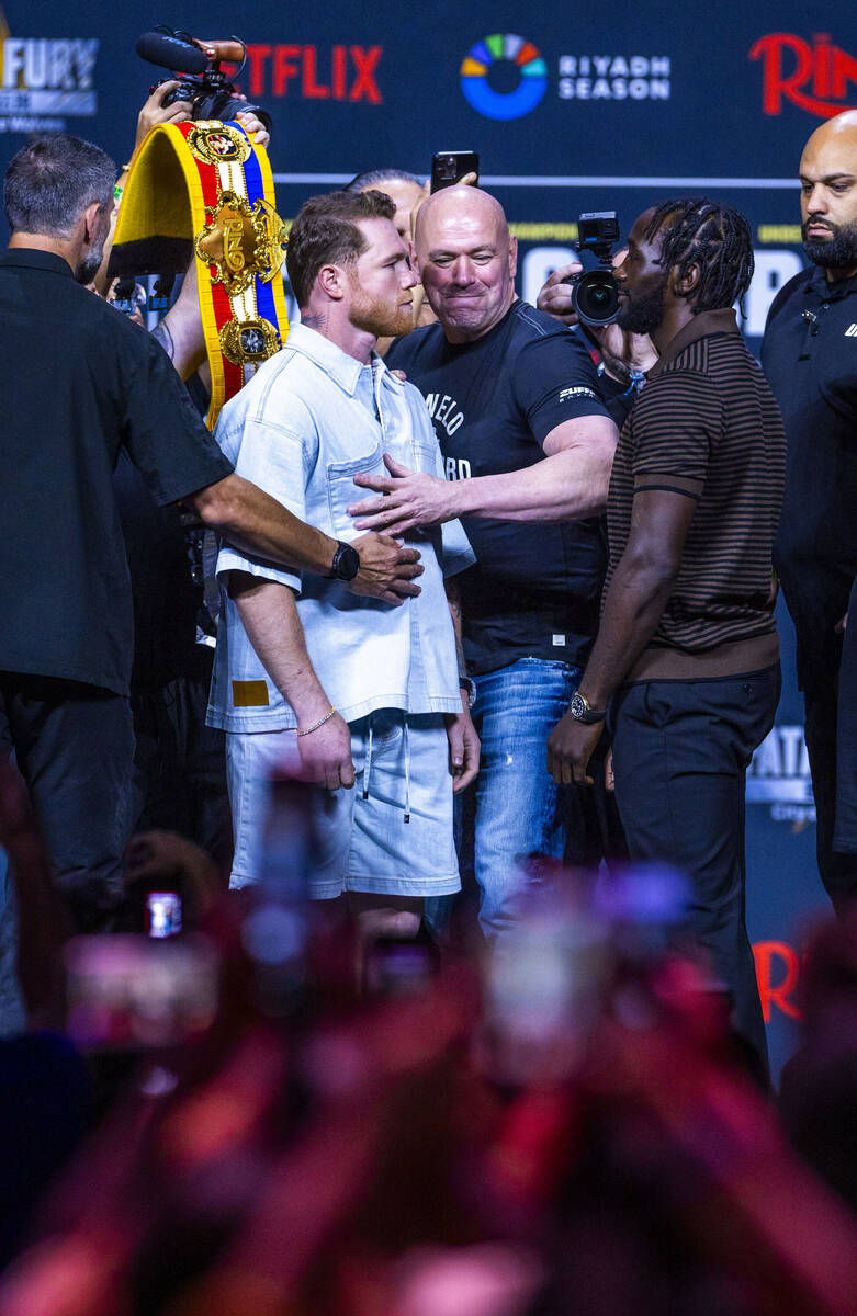 Canelo Alvarez and Terence Crawford face off as Dana White steps in to keep them apart during a ...