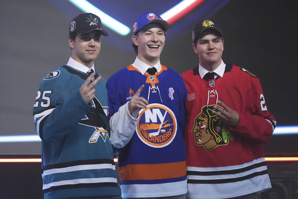 Matthew Schaefer, drafted first by the New York Islanders, middle, stands between Michael Misa, ...