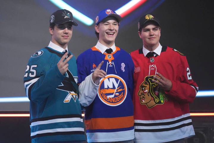 Matthew Schaefer, drafted first by the New York Islanders, middle, stands between Michael Misa, ...